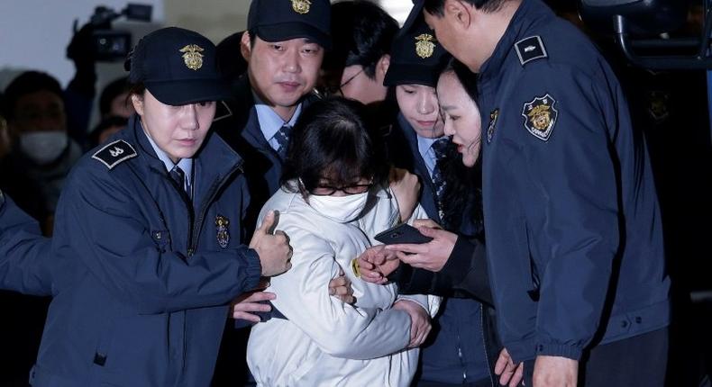 South Korean lawmakers have made fresh efforts to question Choi Soon-sil (C), the jailed confidante of President Park Geun-hye