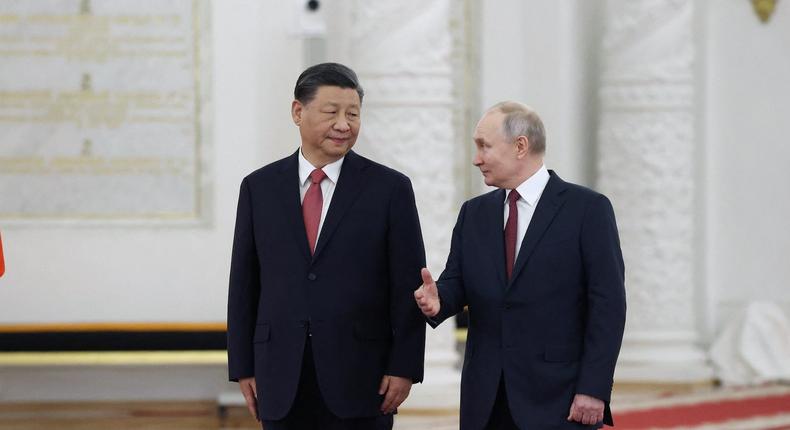 Russian President Vladimir Putin and Chinese President Xi Jinping attend a welcome ceremony before Russia - China talks in narrow format at the Kremlin in Moscow, Russia March 21, 2023Sputnik/Sergei Karpukhin/Pool via REUTERS