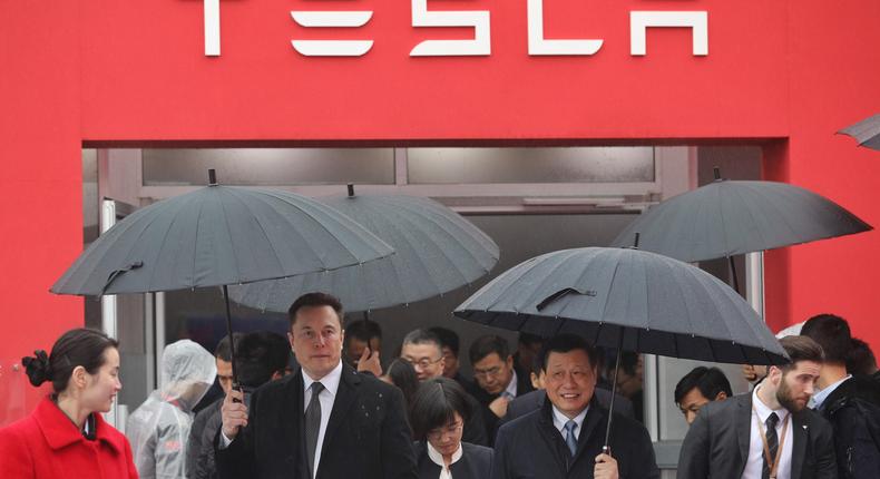 Elon Musk walks with former Shanghai Mayor Ying Yong in 2019
