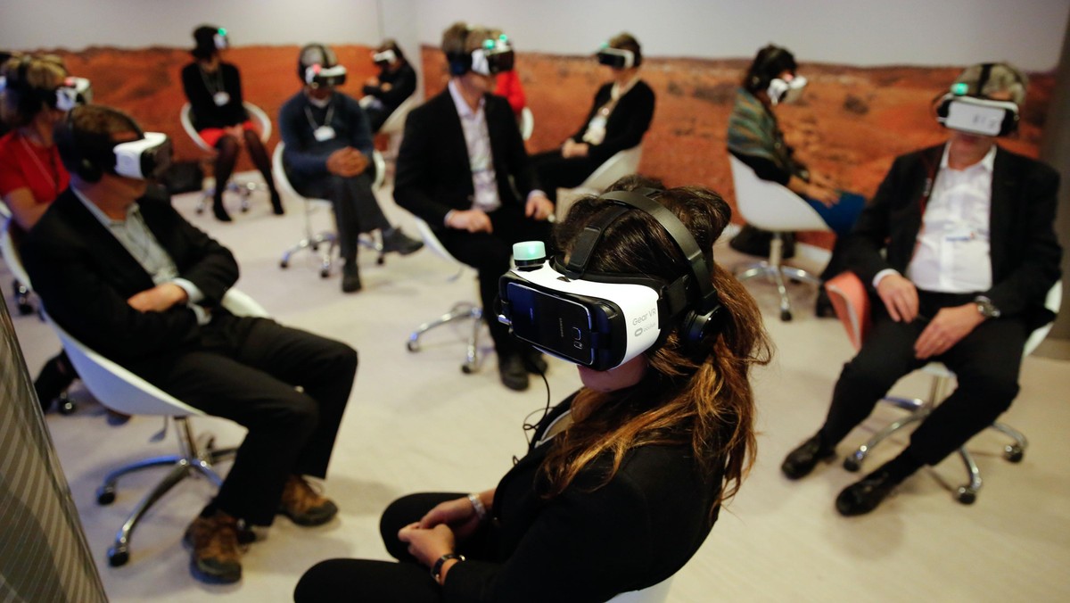 Participants attend the 'Collisions. A Virtual Reality World Premiere' event at the annual meeting o