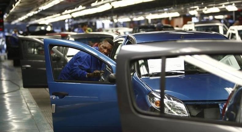 A worker inspects cars at Nissan's manufacturing plant in Rosslyn, outside Pretoria, in a file photo. REUTERS/Siphiwe Sibeko