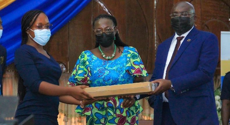 Dr Bawumia presenting a laptop to a student