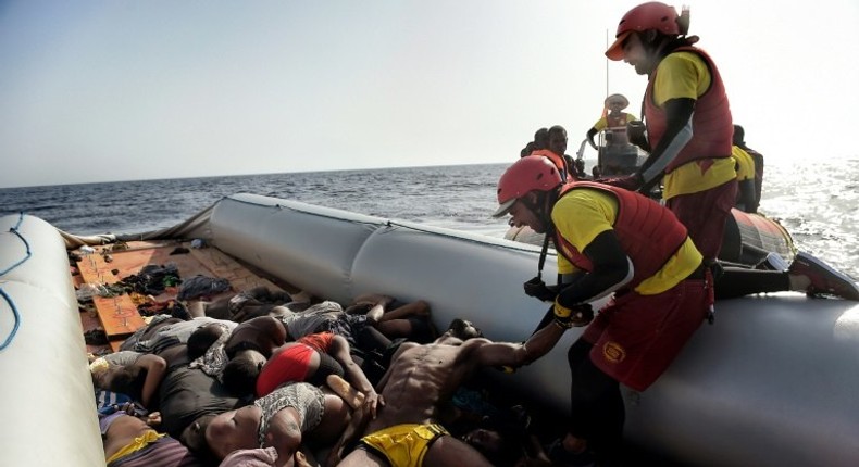 Members of Spanish humanitarian NGO Proactiva Open Arms, drag corpses of refugees and migrants after a rescue operation off the coast of Libya on October 4, 2016