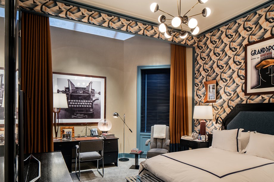 This bedroom's walls are covered in an unusual patterned graphic.