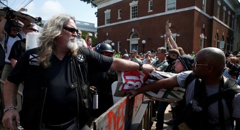 A white supremacist grabbing a counterprotester’s sign during a rally in Charlottesville, Virginia.