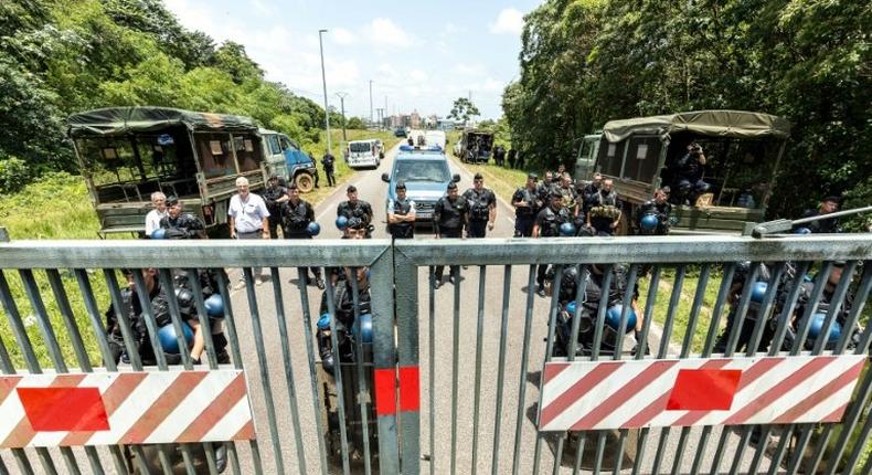 Riot policemen stand at the entrance of the Kourou space center (Centre Spatial Guyanais) during a protest over security and the state of the economy on April 4, 2017 in Kourou, French Guiana