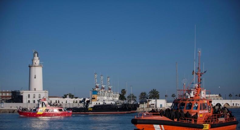 Would-be immigrants stand on a coastguard vessel as they arrive in Spain March 2, 2017, after an inflatable boat carrying 52 people was rescued by the Spanish coastguard, some of the more than 8,000 migrants who had arrived in Spain in 2017 by August