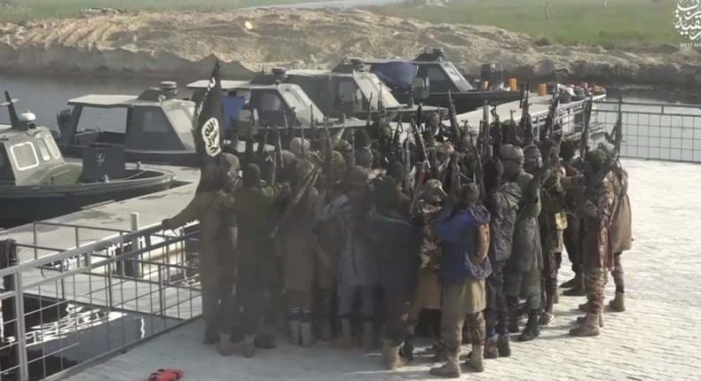  Islamic State West Africa Province militants pledging allegiance to ISIS leader Abu Bakr al-Baghdadi near boats captured in Borno. Still from an ISIS propaganda video released on May 22, 2019.