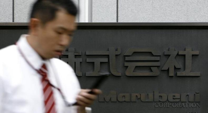 A man walks past a sign of Japanese general trading company Marubeni Corp at the company's head office in Tokyo July 27, 2009. REUTERS/Stringer