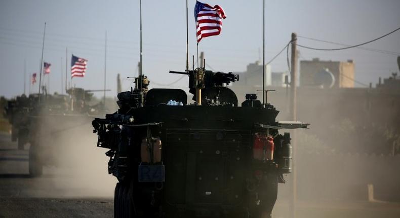 Convoy of US armoured vehicles drives near the village of Yalanli, on the western outskirts of the northern Syrian city of Manbij