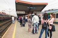 Many people with Luggage on the platform waiting for the delayed train