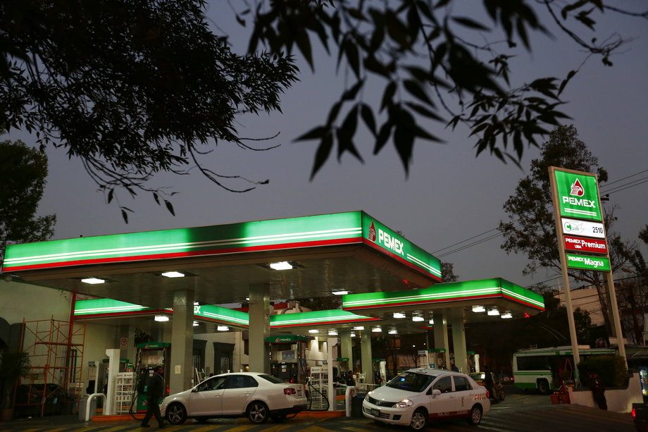 Vehicles beside fuel pumps at a Pemex gas station in Mexico City, January 13, 2015.