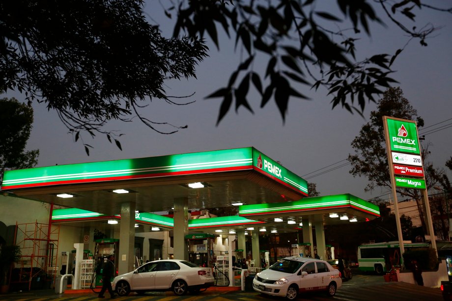 Vehicles beside fuel pumps at a Pemex gas station in Mexico City, January 13, 2015.