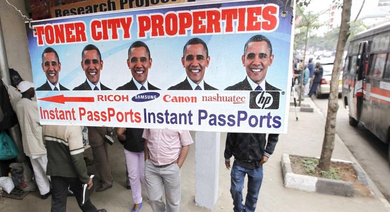 Residents walk past a commercial poster with the portrait photo of the U.S. President Barack Obama ahead of his scheduled State visit in Kenya's capital Nairobi July 23, 2015. REUTERS/Thomas Mukoya