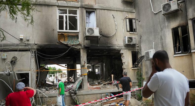 Israelis inspect a damaged residential building after it was hit by a rocket fired from the Gaza Strip, in Ashkelon, Israel, Monday, Oct. 9, 2023.AP Photo/Erik Marmor