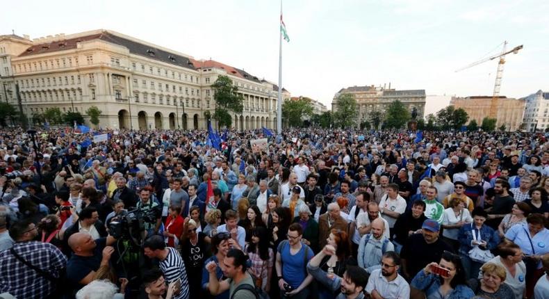 Prostesters gather at the parliament buliding in Budapest, on May 21, 2017, as they take part in a demonstration against tough laws targeting foreign-backed NGOs and higher education institutions, amid rising tensions between Budapest and Brussels