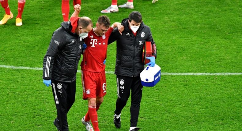 Injury to Germany midfielder Joshua Kimmich (C) cast a shadow over Bayern Munich's 3-2 win at Borussia Dortmund on Saturday