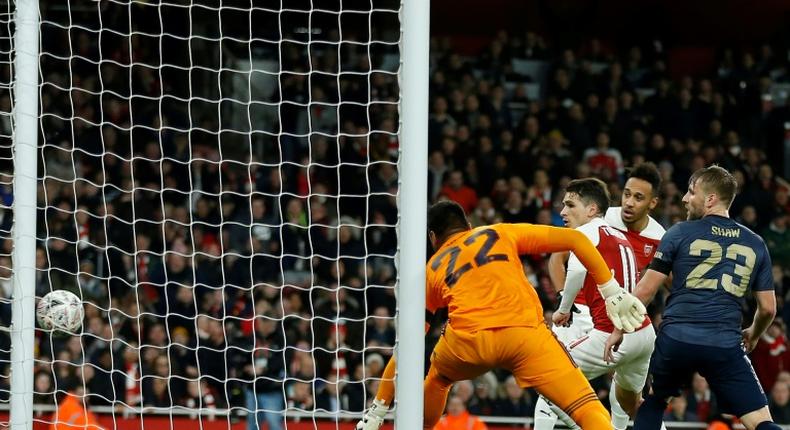 Arsenal's Gabonese striker Pierre-Emerick Aubameyang (2nd L) watches as his shot hits the empty net for Arsenal's first goal during the English FA Cup fourth round football match between Arsenal and Manchester United at the Emirates Stadium in London on January 25, 2019.