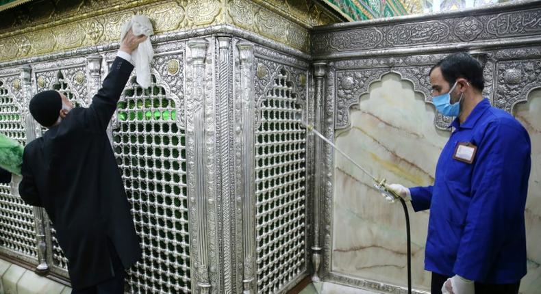 Iranian sanitary workers disinfect the revered Masumeh shrine in the Shiite holy city of Qom, which has been the epicentre of the COVID-19 outbreak in the Islamic republic