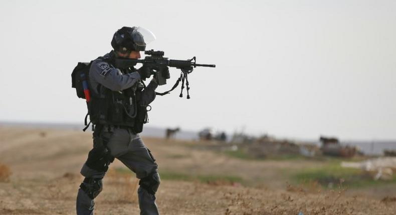 Israeli policeman takes aim in the Bedouin village of Umm al-Heiran, in the Negev desert, where police say they shot dead an Arab-Israeli in a car-ramming attack