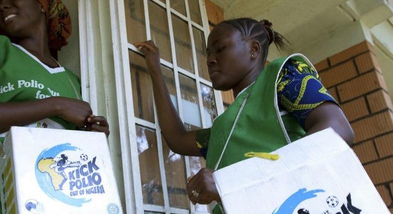 Health officials go from house to house to immunise children against polio.