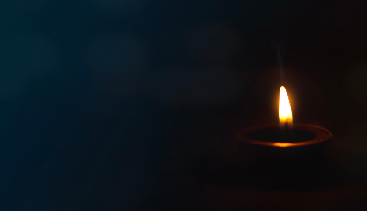 Peace,Concept,,Burning,Candle,On,Dark,Table