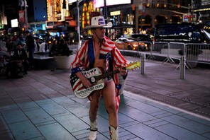 A Naked Cowboy performer supporting Donald Trump walks through Times Square in New York