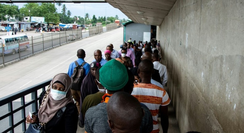 People walk on a pedestrian bridge without adhering to social distancing in Dar es Salaam, Tanzania, in April 2020