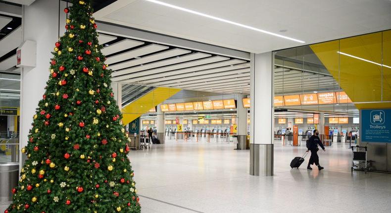 Travelers can save money on holiday airfare by departing the Monday or Tuesday before Christmas weekend and returning midweek, Hopper economist Hayley Berg says.       Leon Neal/Getty Images