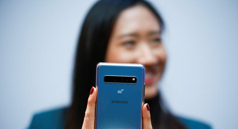 FILE PHOTO: A Samsung employee poses with the new Samsung Galaxy S10 5G smartphone at a press event in London, Britain February 20, 2019. REUTERS/Henry Nicholls
