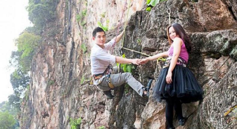 Daring couple hangs from rocks for their pre-wedding shoot