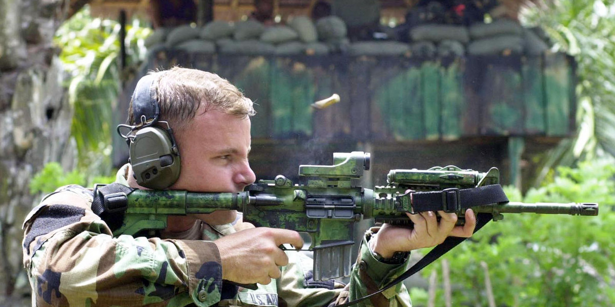 A US Army Ranger test fires his M4 carbine rifle during marksmanship training for Filipino scout rangers taking part in joint military exercises in Isabela, on Basilan Island in the southern Philippines, April 18, 2002.