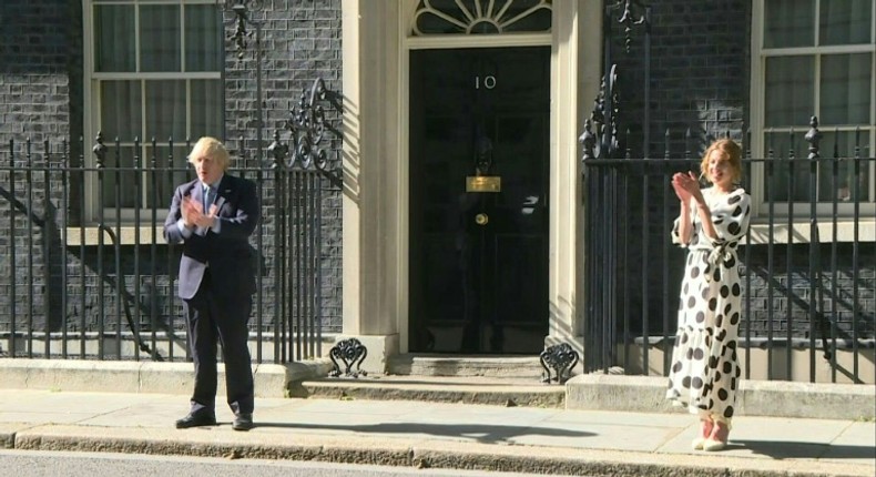 British Prime minister Boris Johnson and 'Clap for Carers' founder Annemarie Plas clap for the NHS outside 10 Downing street