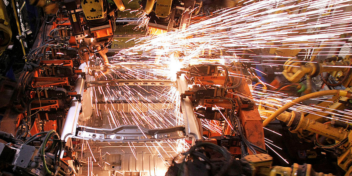 A crossover SUV vehicle is welded by robot arms as it goes through the assembly line at the General Motors Lansing Delta Township Assembly Plant March 10, 2010 in Lansing, Michigan. The Delta plant has more than 3,000 workers on two shifts and is expected to add a third shift of 900-1,000 workers in April. The plant produces the Buick Enclave, Chevrolet Traverse, and GMC Acadia crossover SUVs.