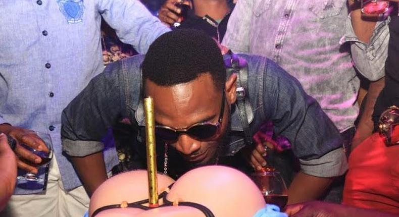 D'Banj savouring his booty on a G-string inspired birthday cake