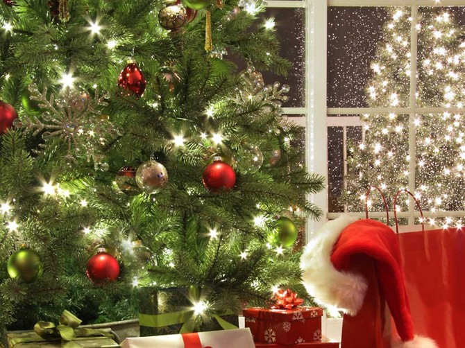 4027_++-stock-photo-brightly-lit-christmas-tree-with-lots-of-gifts-near-window-shutterstock_41220469