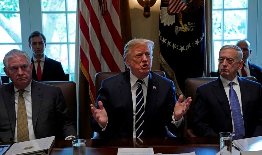 Flanked by Secretary of State Rex Tillerson and Defense Secretary Jim Mattis, President Donald Trump meets with cabinet members at the White House, October 16, 2017.