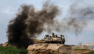Israeli soldiers drive an tanks on the border with the Gaza Strip, in southern Israel on Feb. 13, 2024.AP Photo/Ariel Schalit