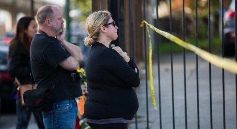 People mourn near the site of a devastating fire on December 4, 2016 in Oakland, California.