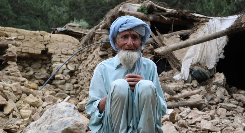 An Afghan man sits near his house that was destroyed in an earthquake in the Spera District of the southwestern part of Khost Province, Afghanistan, on June 22, 2022.