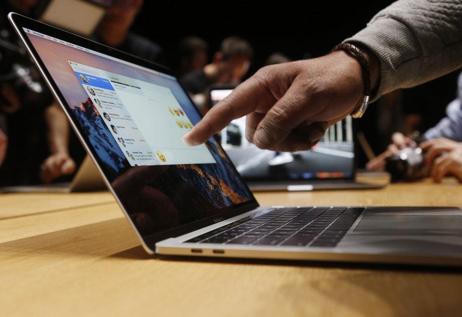 A guest points to a new MacBook Pro during an Apple media event in Cupertino.