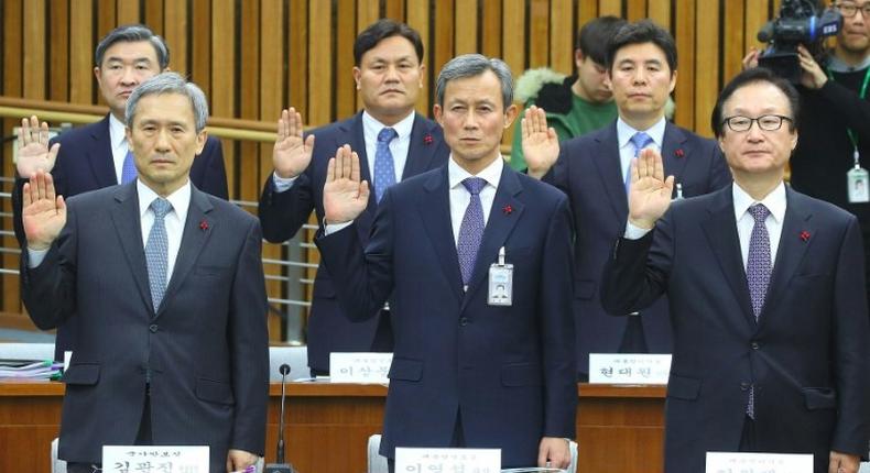 National Security Office chief Kim Kwan-Jin (L) and other presidential aides take an oath during a hearing on South Korean President Park Geun-Hye's corruption scandal in Seoul