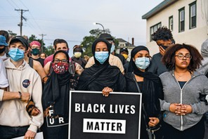 TENSIONS BOIL On June 1, a week after George Floyd’s death in police custody, protesters gather at a makeshift memorial for him in Minneapolis. Protests and riots broke out across the country in response to how Floyd and other black men are treated by the police and the lack of swift arrests and charges for all four former officers involved in his killing.