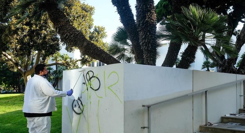 Graffiti being cleaned off an LA courthouse.
