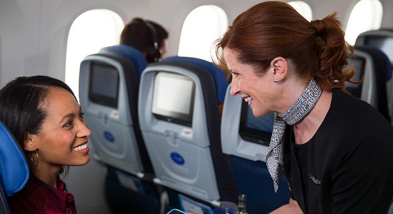 A United Airlines flight attendant with an iPhone.