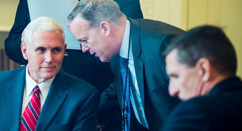 United States Vice President Mike Pence talks with White House Press Secretary Sean Spicer as President Donald Trump speaks with President of Russia, Vladimir Putin on the telephone in the Oval Office on January 28, 2017 in Washington, DC.