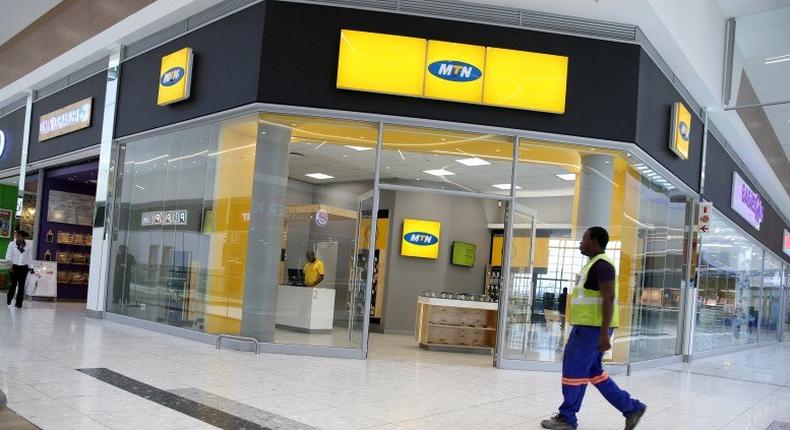 A worker walks past an outlet of South Africa's MTN Group in Johannesburg, South Africa, February 23, 2016. 