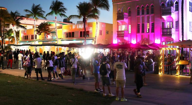 People walk along Ocean Drive on March 18, 2021 in Miami Beach, Florida.
