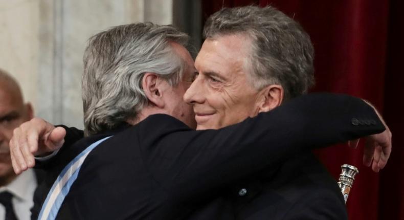 Outgoing president Mauricio Macri embraces his leftist rival and new Argentine President Alberto Fernandez at the inauguration in Buenos Aires on December 10, 2019