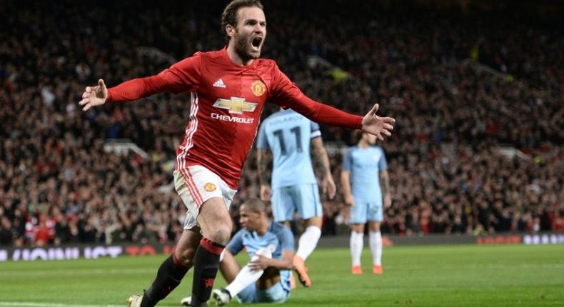 Manchester United's Spanish midfielder Juan Mata celebrates after scoring the opening goal against Manchester City on October 26, 2016